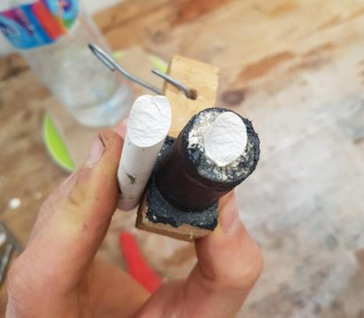 Chalk sample showing a helicoidal fracture surface next to the torsion rig